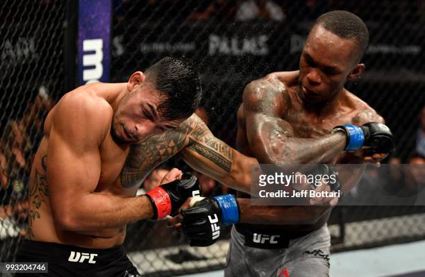 Israel Adesanya of Nigeria elbows Brad Tavares in their middleweight bout during The Ultimate Fighter Finale event inside The Pearl concert theater...