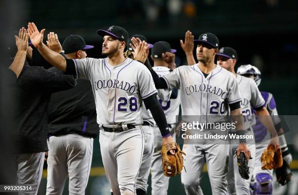 Nolan Arenado of the Colorado Rockies and Ian Desmond of the Colorado Rockies greet their teammates as they celebrate their win against the Seattle...