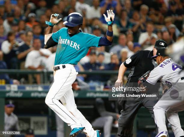 Dee Gordon of the Seattle Mariners is tagged out at home by German Marquez of the Colorado Rockies in the sixth inning at Safeco Field on July 6,...