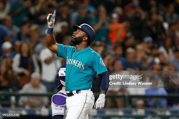 Denard Span of the Seattle Mariners points to the sky as he crosses home after hitting a home run in the sixth inning against the Colorado Rockies at...