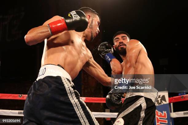 Rigoberto Hermosillo connects a punch to Ernesto Guerrero in the fourth round of the Super Featherweight fight of LA Fight Club at The Belasco...