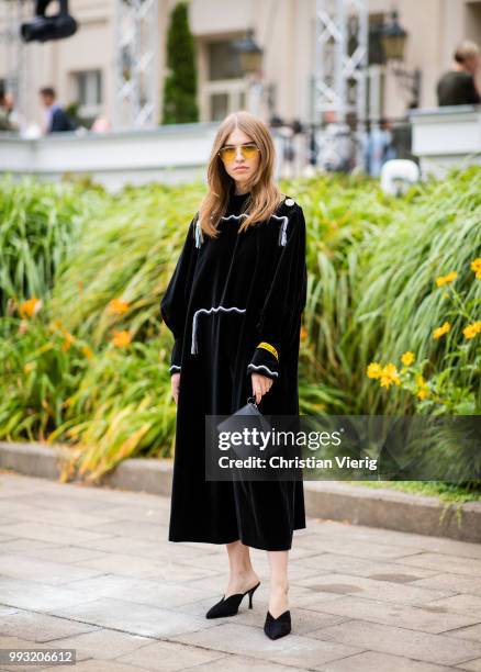 Swantje Soemmer wearing black dress, bag with print pouch seen outside Der Berliner Salon during the Berlin Fashion Week July 2018 on July 6, 2018 in...