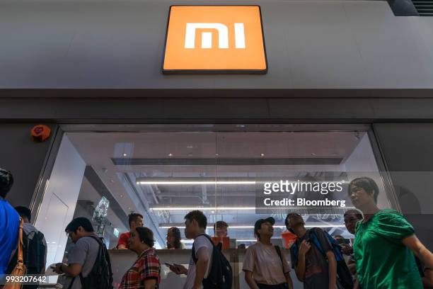 Customers wait in line to purchase Xiaomi Corp. Mi 8 smartphones outside a Xiaomi store in Hong Kong, China, on Friday, July 6, 2018. The tussle...