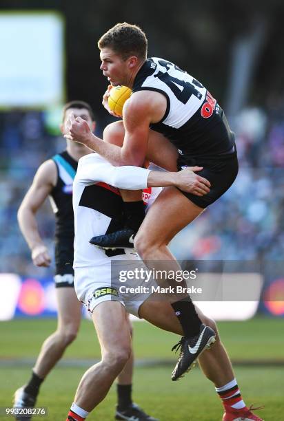 Dan Houston of Port Adelaide run into Maverick Weller of the Saints during the round 16 AFL match between the Port Adelaide Power and the St Kilda...