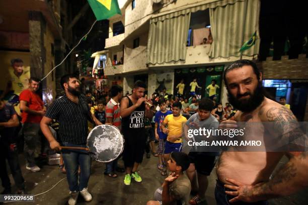 Lebanese fans perform a batucada prior to the Russia 2018 World Cup quarter-final football match between Brazil and Belgium in the Ersal district,...