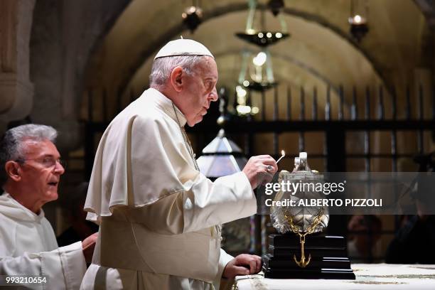 Pope Francis lights the uniflamma lamp at the tomb of Saint Nicholas in the crypt of the Pontifical Basilica of St Nicholas in Bari, in the Apulia...