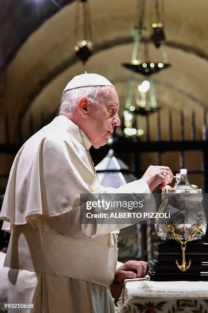 Pope Francis lights the uniflamma lamp at the tomb of Saint Nicholas in the crypt of the Pontifical Basilica of St Nicholas in Bari, in the Apulia...