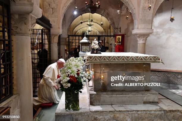 Pope Francis prays at the tomb of Saint Nicholas in the crypt of the Pontifical Basilica of St Nicholas in Bari, in the Apulia region in southern...