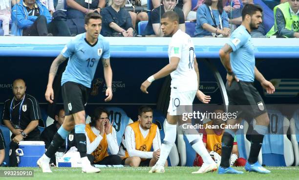 Edinson Cavani of Uruguay on the bench while Kylian Mbappe of France and Luis Suarez of Uruguay look on during the 2018 FIFA World Cup Russia Quarter...