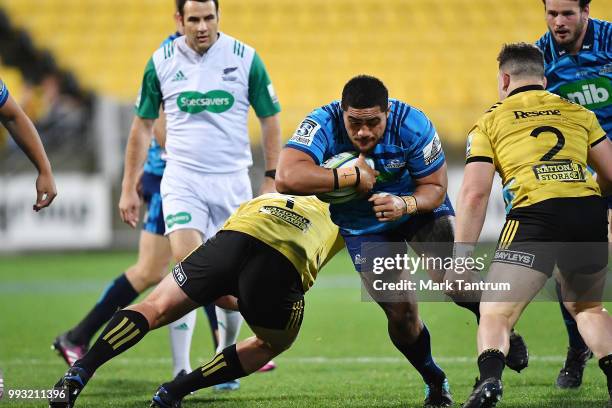 Ofa Tuungafasi of the Blues is tackled during the round 18 Super Rugby match between the Hurricanes and the Blues at Westpac Stadium on July 7, 2018...