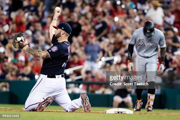 Matt Adams of the Washington Nationals retires Cameron Maybin of the Miami Marlins during the sixth inning at Nationals Park on July 06, 2018 in...