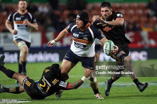 Brumbies Leslie Leuluaialii-Makin passes the ball in the tackle during the round 18 Super Rugby match between the Chiefs and the Brumbies at FMG...