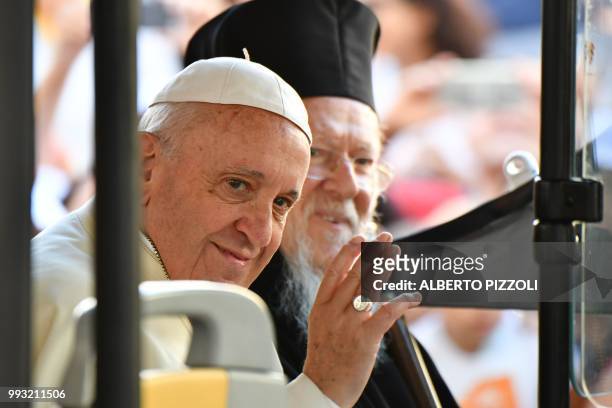 Pope Francis waves next to Ecumenic Patriarch of the Orthodox Church, Bartolomeo I at the end of their visit of the crypt with the tomb of Saint...