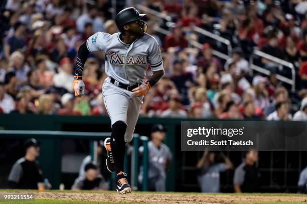 Cameron Maybin of the Miami Marlins watches a long fly ball that was ulitmately caught by Bryce Harper of the Washington Nationals during the ninth...