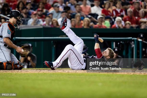 Mark Reynolds of the Washington Nationals dodges an inside pitch in front of J.T. Realmuto of the Miami Marlins during the ninth inning at Nationals...