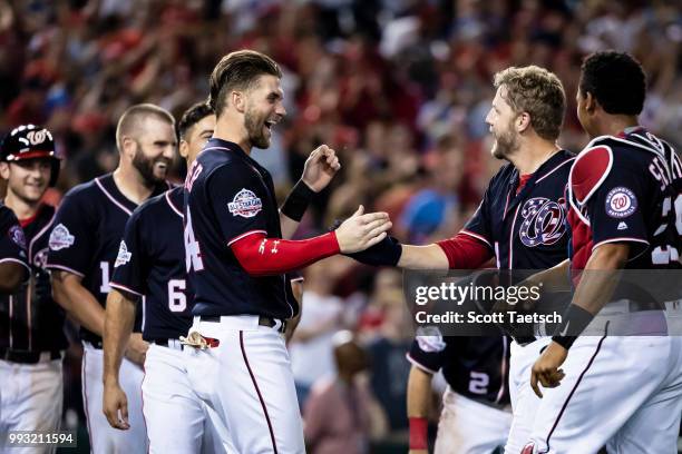 Washington Nationals players celebrate after Mark Reynolds hits the game winning home run against the Miami Marlins during the ninth inning at...