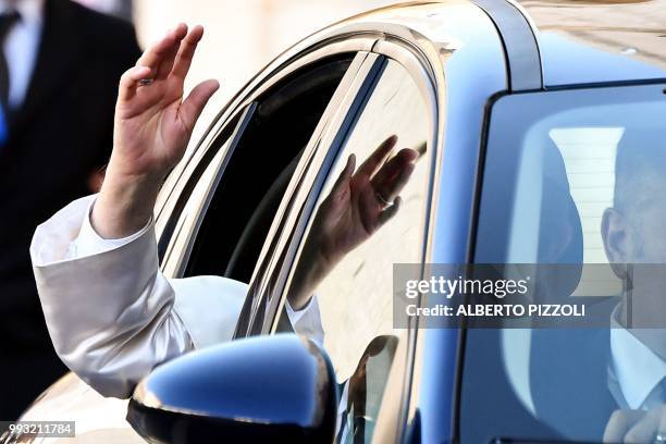 Pope Francis waves as he arrives for a meeting with religious leaders at the Pontifical Basilica of St Nicholas in Bari, in the Apulia region in...