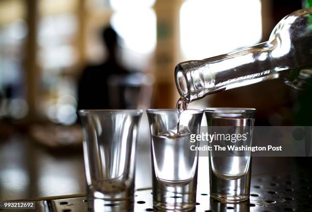 Mezcal, an agave spirit , is poured into shot glasses at Doves Luncheonette in the Wicker Park neighborhood of Chicago, Illinois, May 7, 2015.