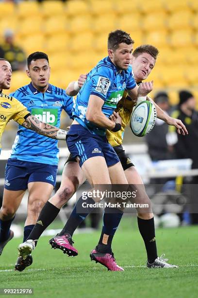 Matt Duffie of the Blues is tackled by Jordie Barrett of the Hurricanes during the round 18 Super Rugby match between the Hurricanes and the Blues at...