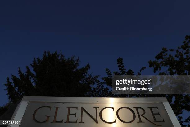 Light reflects on signage at sunset near the Glencore Plc headquarters office in Baar, Switzerland, on Friday, July 6, 2018. Glencore will buy back...