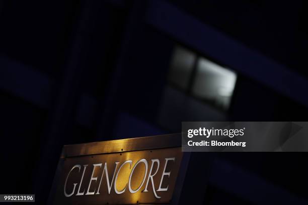 Light reflects on signage at sunset near the Glencore Plc headquarters office in Baar, Switzerland, on Friday, July 6, 2018. Glencore will buy back...