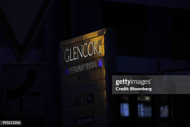 Light reflects on signage at sunset near the Glencore Plc headquarters office in Baar, Switzerland, on Friday, July 6, 2018. Glencore will buy back...