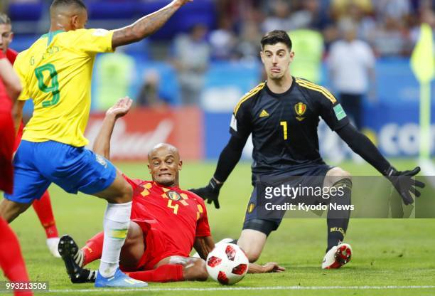 Belgium's goalkeeper Thibaut Courtois and defender Vincent Kompany block a shoot by Brazil's Gabriel Jesus during the second half of a World Cup...