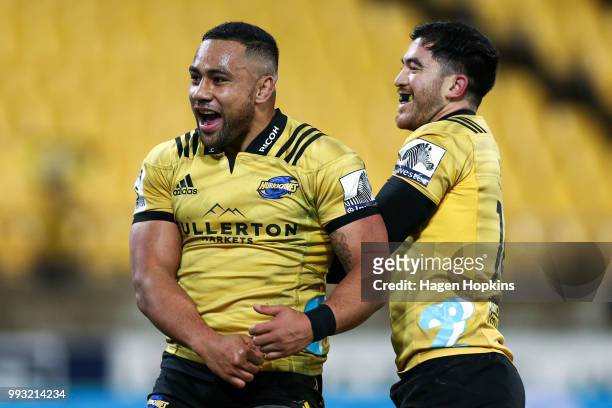 Ngani Laumape of the Hurricanes celebrates with Nehe Milner-Skudder after scoring a try during the round 18 Super Rugby match between the Hurricanes...