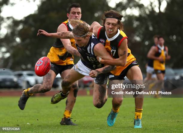 Baxter Mensch of the Geelong Falcons and Finlay Bayne of the Dandenong Stingrays compete for the ball during the round 11 TAC Cup match between...