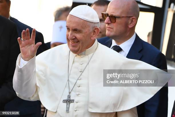 Pope Francis waves to believers as he arrives after his mass at the 'Rotonda' on the Lungomare of Bari, to meet with other religious leaders at the...