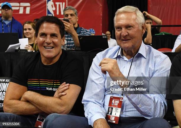 Dallas Mavericks owner Mark Cuban and Los Angeles Clippers executive board member Jerry West talk as they watch a 2018 NBA Summer League game between...