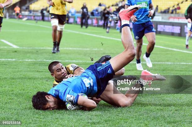 Melani Nanai of the Blues defends in the try line against Julian Savea of the Hurricanes during the round 18 Super Rugby match between the Hurricanes...