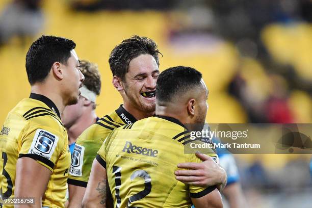 Sam Henwood of the Hurricanes congratulates Ngani Laumape of the Hurricanes for scoring during the round 18 Super Rugby match between the Hurricanes...