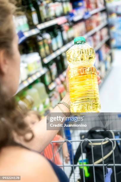 shopping for cooking oil - canola oil stock pictures, royalty-free photos & images