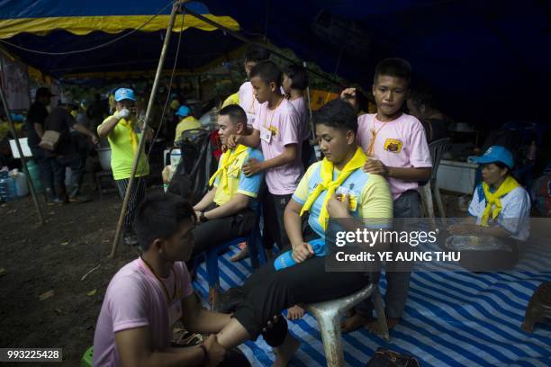 Thai volunteers receive free massage at an outpost in the Tham Luang cave area as rescue operation continues for the 12 boys and their football team...