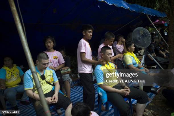 Thai volunteers receive free massage at an outpost in the Tham Luang cave area as rescue operation continues for the 12 boys and their football team...