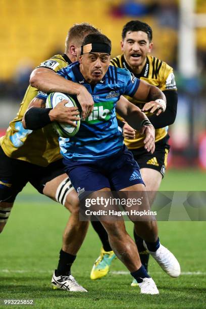 Augustine Pulu of the Blues is tackled by Brad Shields of the Hurricanes during the round 18 Super Rugby match between the Hurricanes and the Blues...