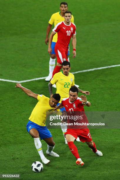 Filip Kostic of Serbia battles for the ball with Casemiro and Fagner of Brazil during the 2018 FIFA World Cup Russia group E match between Serbia and...