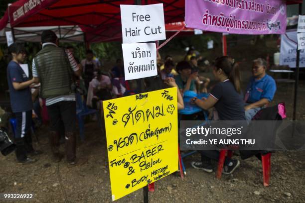 Thai volunteers set up free hair cut and body massage service for hundreds of local and foreign rescue personnel at the the Tham Luang cave area as...