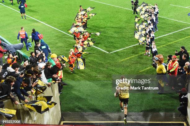 Brad Shields of the Hurricanes runs on to the field before the round 18 Super Rugby match between the Hurricanes and the Blues at Westpac Stadium on...