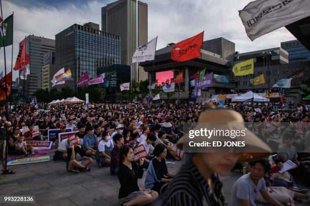 Protesters hold placards reading 'Abolish punishment for abortion' as they protest South Korean abortion laws in Gwanghwamun plaza in Seoul on July...