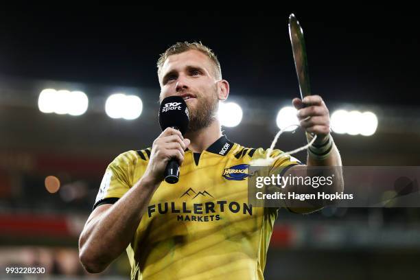 Brad Shields of the Hurricanes makes a speech while holding his pounamu mere, gifted in recognition of his 100th Super Rugby game during the round 18...