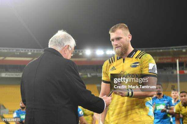 Brad Shields of the Hurricanes is presented a Pounamu Mere for his 100th match after the round 18 Super Rugby match between the Hurricanes and the...