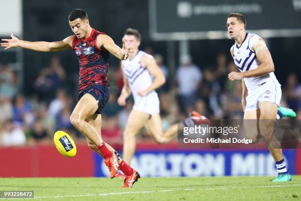 Alex Neal-Bullen of the Demons kicks the ball from Stephen Hill of the Dockers during the round 16 AFL match between the Melbourne Demons and the...