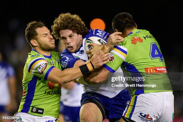 Adam Elliott of the Bulldogs is tackled during the round 17 NRL match between the Canterbury Bulldogs and the Canberra Raiders at Belmore Sports...