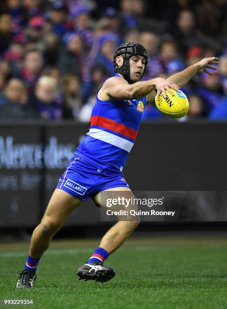 Caleb Daniel of the Bulldogs kicks during the round 16 AFL match between the Western Bulldogs and the Hawthorn Hawks at Etihad Stadium on July 7,...