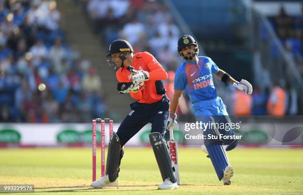 England wicketkeeper Jos Buttler takes the ball whilst India captain Virat Kohli makes his ground during the 2nd Vitality T20 International between...