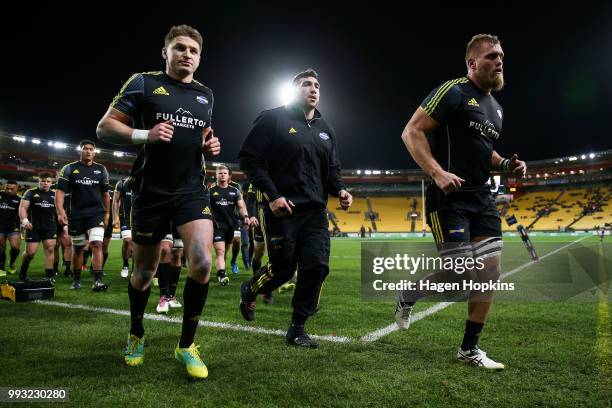 Beauden Barrett, Jeff Toomaga-Allen and Brad Shields of the Hurricanes leave the field after warming up during the round 18 Super Rugby match between...