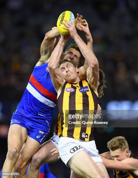Ben McEvoy of the Hawks marks infront of Marcus Bontempelli of the Bulldogs during the round 16 AFL match between the Western Bulldogs and the...