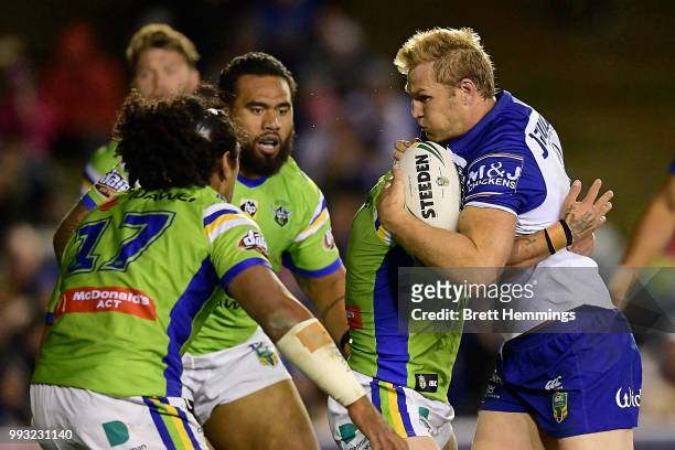 Aiden Tolman of the Bulldogs is tackled during the round 17 NRL match between the Canterbury Bulldogs and the Canberra Raiders at Belmore Sports...
